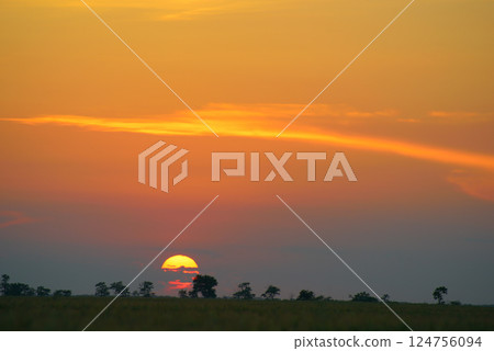 Solar disk and beautiful red sunset over the earth's surface. 124756094
