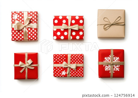 Luxurious holiday gift boxes wrapped in red and kraft paper, adorned with elegant satin ribbons and twine bows, featuring polka dots, snowflake patterns, and a classic festive aesthetic 124756914