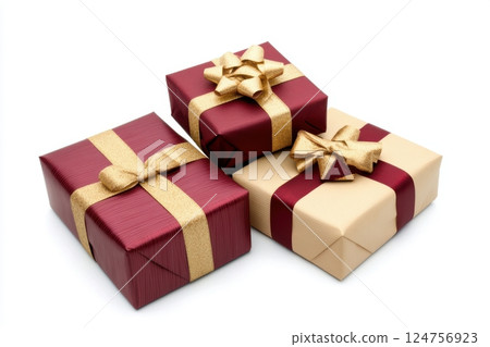 elegant holiday gift set with three beautifully wrapped presents in red and gold, adorned with luxurious ribbons and carefully tied bows, rich textured paper, festive celebration mood 124756923