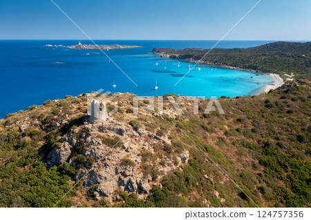Aerial view of sandy beach, old tower on the mountain, sea bay 124757356