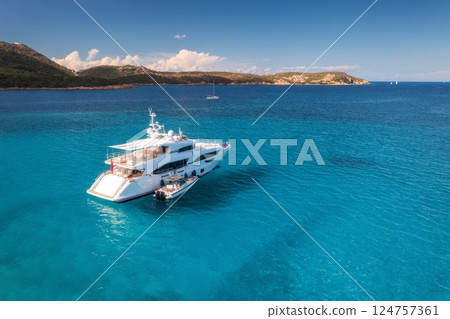 Aerial view of luxury yacht on blue sea at sunny day in summer Aerial view of luxury yacht on blue sea at sunny day in summer 124757361