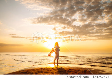 Young woman with American flag on beach. Patriotic holiday. Independence Day concept Young woman with American flag on beach. Patriotic holiday. Independence Day concept 124757375
