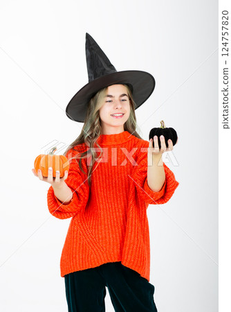 Portrait smiling girl in witch black hat, with pumpkin jack sweet candy. Isolated white background 124757820