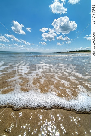 Calm Ocean Waves Under a Blue Sky With Soft Clouds Creating a Serene Atmosphere Calm Ocean Waves Under a Blue Sky With Soft Clouds Creating a Serene Atmosphere 124757941