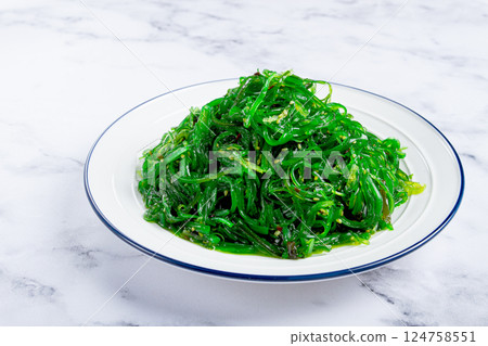 Chuka salad made from fresh seaweed, with sesame dressing, served on a white plate, no people, Chuka salad made from fresh seaweed, with sesame dressing, served on a white plate, no people, 124758551
