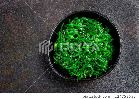 Chuka salad, made from fresh seaweed, with sesame dressing, served in a black bowl, with chopsticks, Chuka salad, made from fresh seaweed, with sesame dressing, served in a black bowl, with chopsticks, 124758553