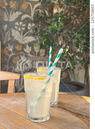 Mojito cocktail with fresh lemon and ice. Two glasses with refreshing citrus lemonade drink Mojito cocktail with fresh lemon and ice. Two glasses with refreshing citrus lemonade drink 124758607
