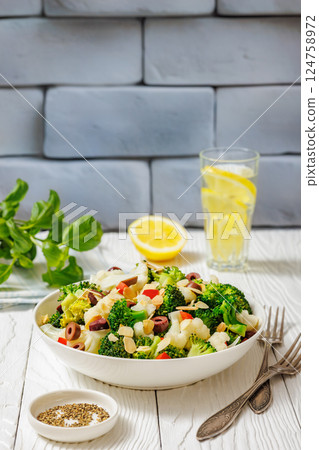 Italian Broccoli Cauliflower Salad in a white bowl 124758972