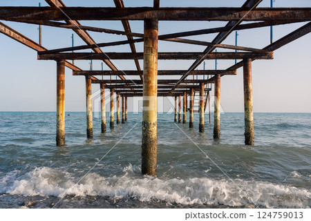 Under the abandoned rusty pier. 124759013