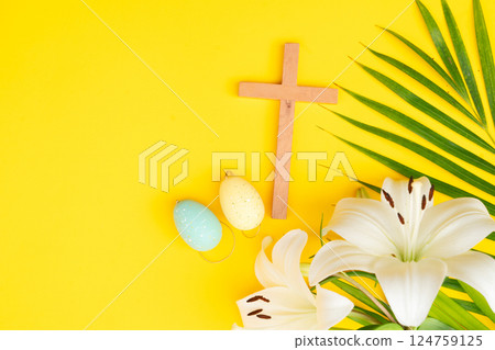 A wooden cross with a Bible and bread on a palm leaves pattern, a Palm Sunday theme A wooden cross with a Bible and bread on a palm leaves pattern, a Palm Sunday theme 124759125