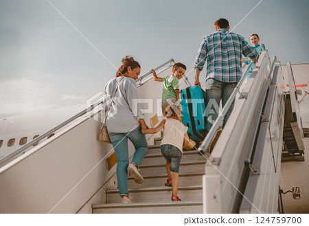A Family Joyfully Boarding an Airplane, Eagerly Anticipating Their Exciting Vacation Adventure A Family Joyfully Boarding an Airplane, Eagerly Anticipating Their Exciting Vacation Adventure 124759700