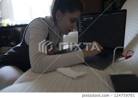 Focused Workflow A Student is Engaged in Coding with a Laptop and Concentrating Hard Focused Workflow A Student is Engaged in Coding with a Laptop and Concentrating Hard 124759701