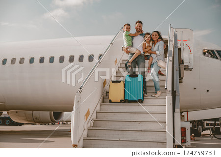 A Happy Family Enjoying Their Travel Experience Together at the Airport Right Now A Happy Family Enjoying Their Travel Experience Together at the Airport Right Now 124759731
