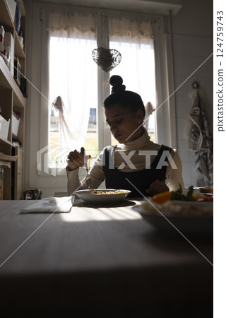 Enjoying a delicious breakfast in a cozy kitchen with warm sunlight streaming through the windows Enjoying a delicious breakfast in a cozy kitchen with warm sunlight streaming through the windows 124759743