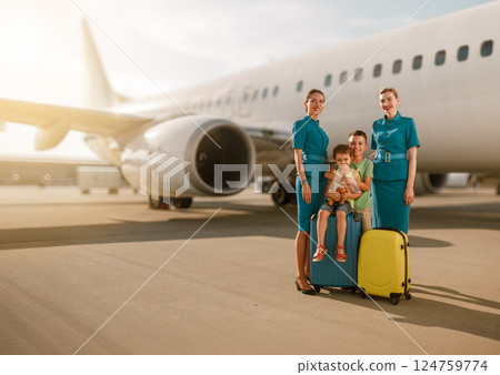Traveling as a family together with the flight crew at the bustling airport environment 124759774