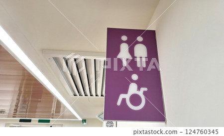 Purple accessible restroom sign with male, female, and wheelchair symbols Purple accessible restroom sign with male, female, and wheelchair symbols 124760345
