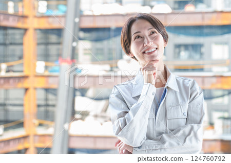 A female worker thinking at a construction site A female worker thinking at a construction site 124760792