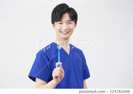 Dentist man holding toothbrush portrait white background 124762040
