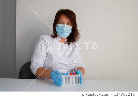 Medical laboratory nurse preparing test tubes for making blood tests 124762218