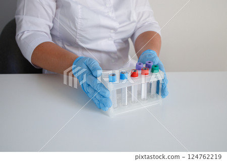 Medical laboratory nurse preparing test tubes for making blood tests Medical laboratory nurse preparing test tubes for making blood tests 124762219