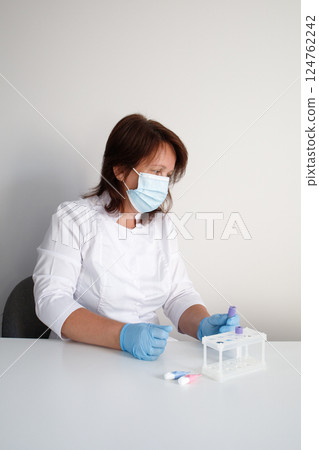 Medical laboratory nurse preparing workplace for making children blood tests Medical laboratory nurse preparing workplace for making children blood tests 124762242