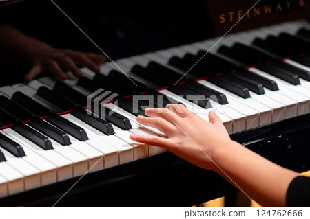 Hands of a man playing the piano Hands of a man playing the piano 124762666