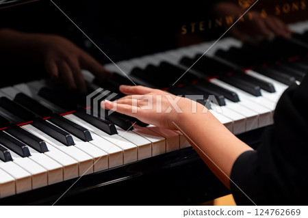 Hands of a man playing the piano 124762669