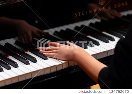 Hands of a man playing the piano 124762670
