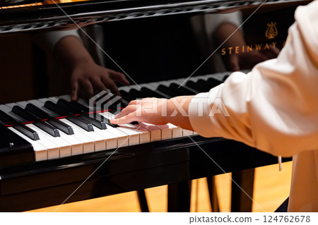 Hands of a man playing the piano 124762678