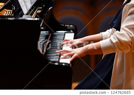 Hands of a man playing the piano 124762685