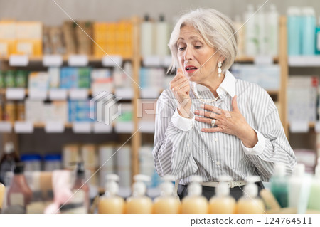 Elderly woman with cough in pharmacy 124764511