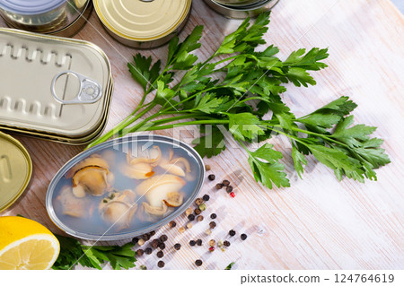 Open tin can with sea clams in its own juice 124764619