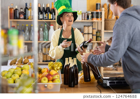 Young woman seller offers beer to buyer Young woman seller offers beer to buyer 124764688