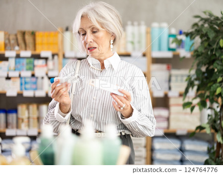 pensioner chooses an ointment for joints 124764776