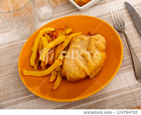 Traditional Spanish dish is goat cheese and pepper booklets with French fries 124764782
