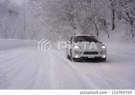 Car driving through the snow in winter Car driving through the snow in winter 124764784
