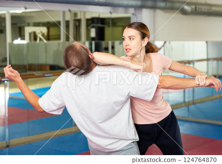 Young woman exercising elbow strike during self-protection training 124764870