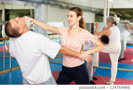 Woman performing chin strike during self-defence training 124764960