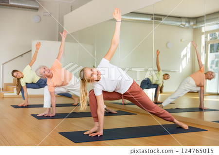 Group of women exercising during yoga class 124765015