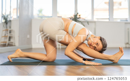 Different yoga poses performed by a slender girl in gym 124765053