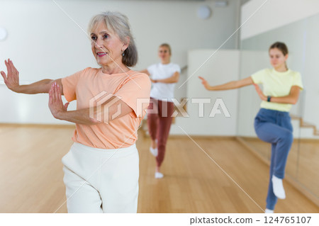 Mature female dancing with other women Mature female dancing with other women 124765107