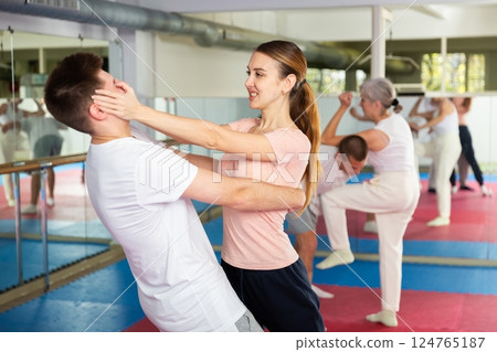 Self-defense course - woman strikes painful blow in the eyes of man Self-defense course - woman strikes painful blow in the eyes of man 124765187