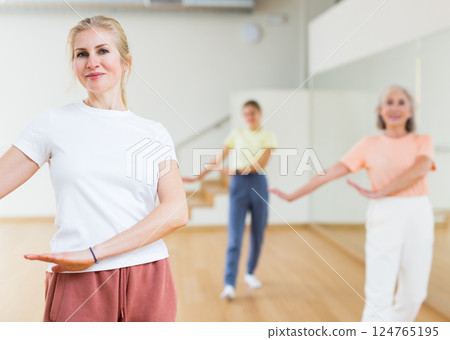 Woman dancing during group class Woman dancing during group class 124765195