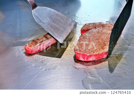 Steak being grilled on a hot plate Steak being grilled on a hot plate 124765410