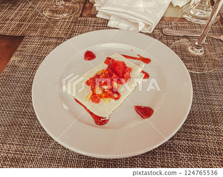 Crepes with strawberry sauce on a white plate in a restaurant Crepes with strawberry sauce on a white plate in a restaurant 124765536