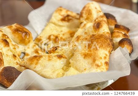 Baked pita bread on the table in a bakery shop. Baked pita bread on the table in a bakery shop. 124766439