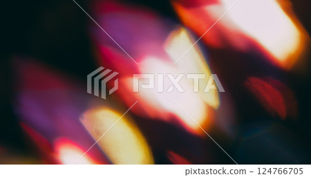 Kaleidoscope glow. Blur magic radiant. Defocused purple yellow orange lens reflection round light circles on abstract art dark black background. 124766705