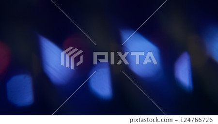 Bokeh flare. Blur circle shine. Defocused blue color sparkle lens optical radiant floating abstract art dark black background. 124766726