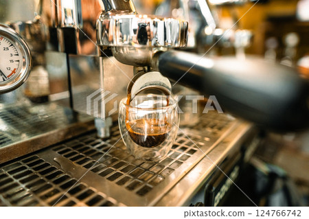 Coffee flows from the coffee maker Coffee flows from the coffee maker 124766742