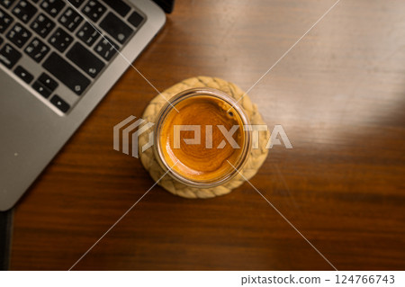 Espresso shot in a glass on a desk 124766743